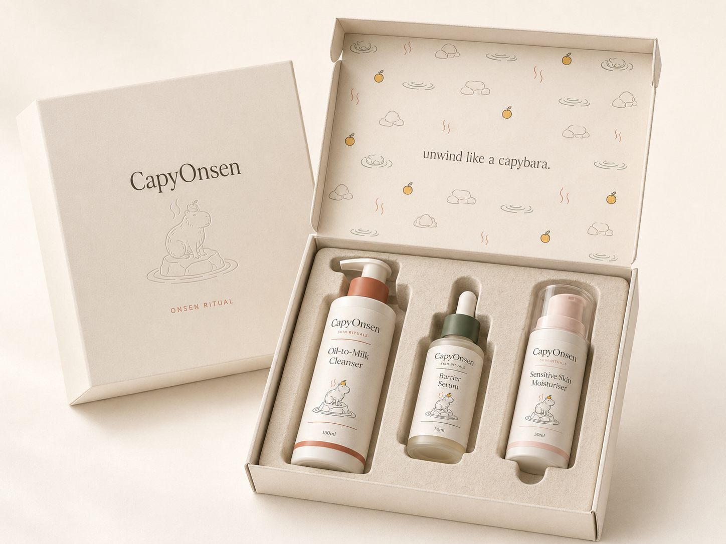 The Onsen Ritual gift set: three products nested in a minimal box, 'unwind like a capybara' printed inside the lid